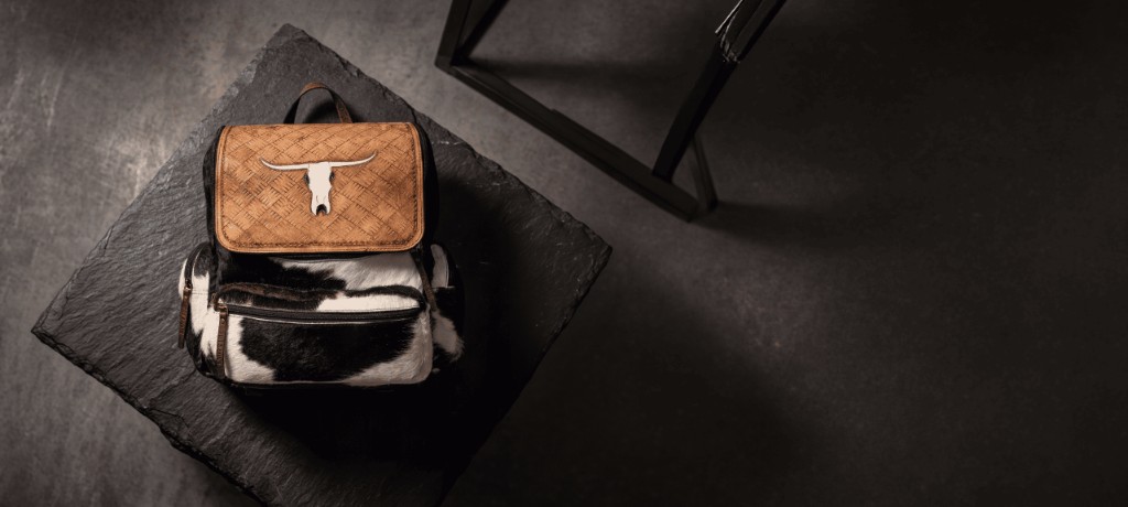 HydeKraft hand-tooled leather backpack with hair-on hide — Western artisan leather craft